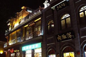 Beijing Private Night Walking Tour: Qianmen Street, Tian'ammen Square and Wangfujing Street - Qianmen Street at night: old lanes, famous brands, and snack-friendly energy